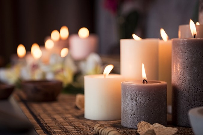 decor with candles - lit grey and white candles clustered