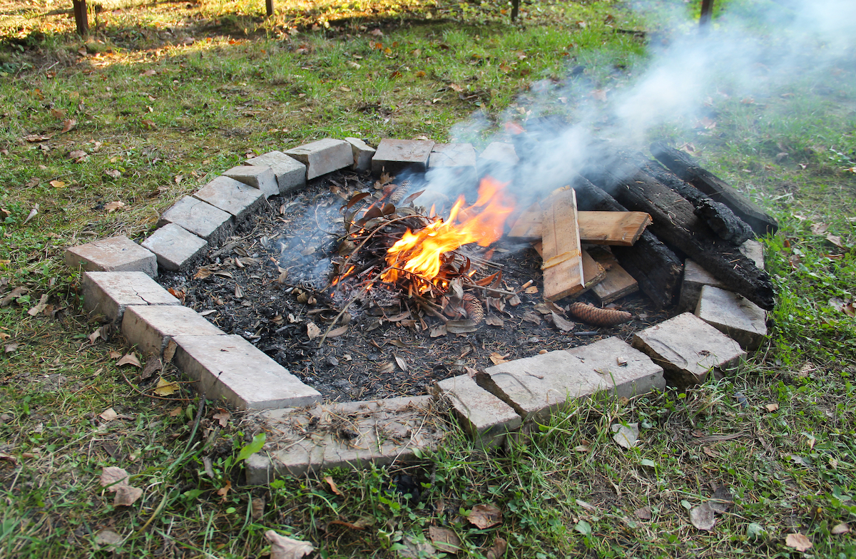 DIY fire pit poorly constructed with fire burning inside