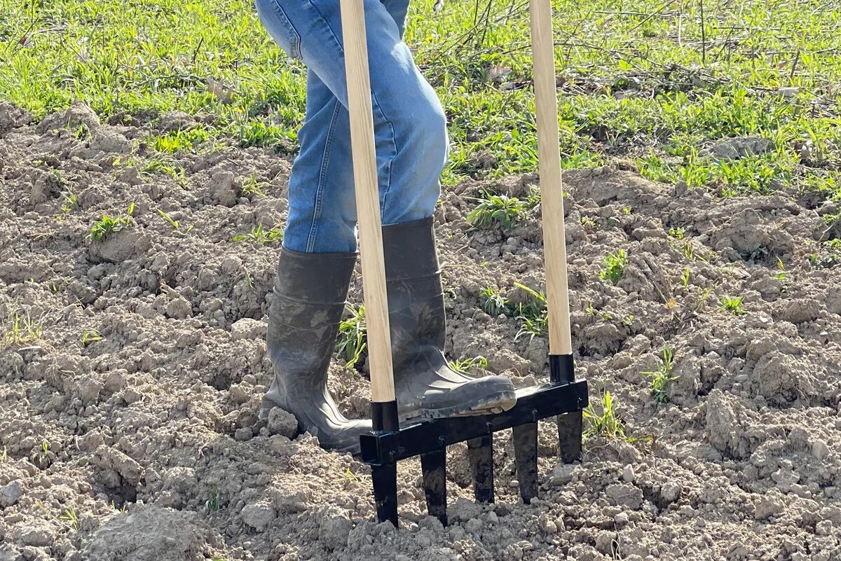 how to till a garden without a tiller - person using broadfork in ground