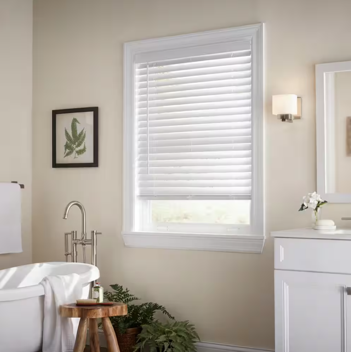 A bathroom with yellow walls and a small window with Venetian blinds. 
