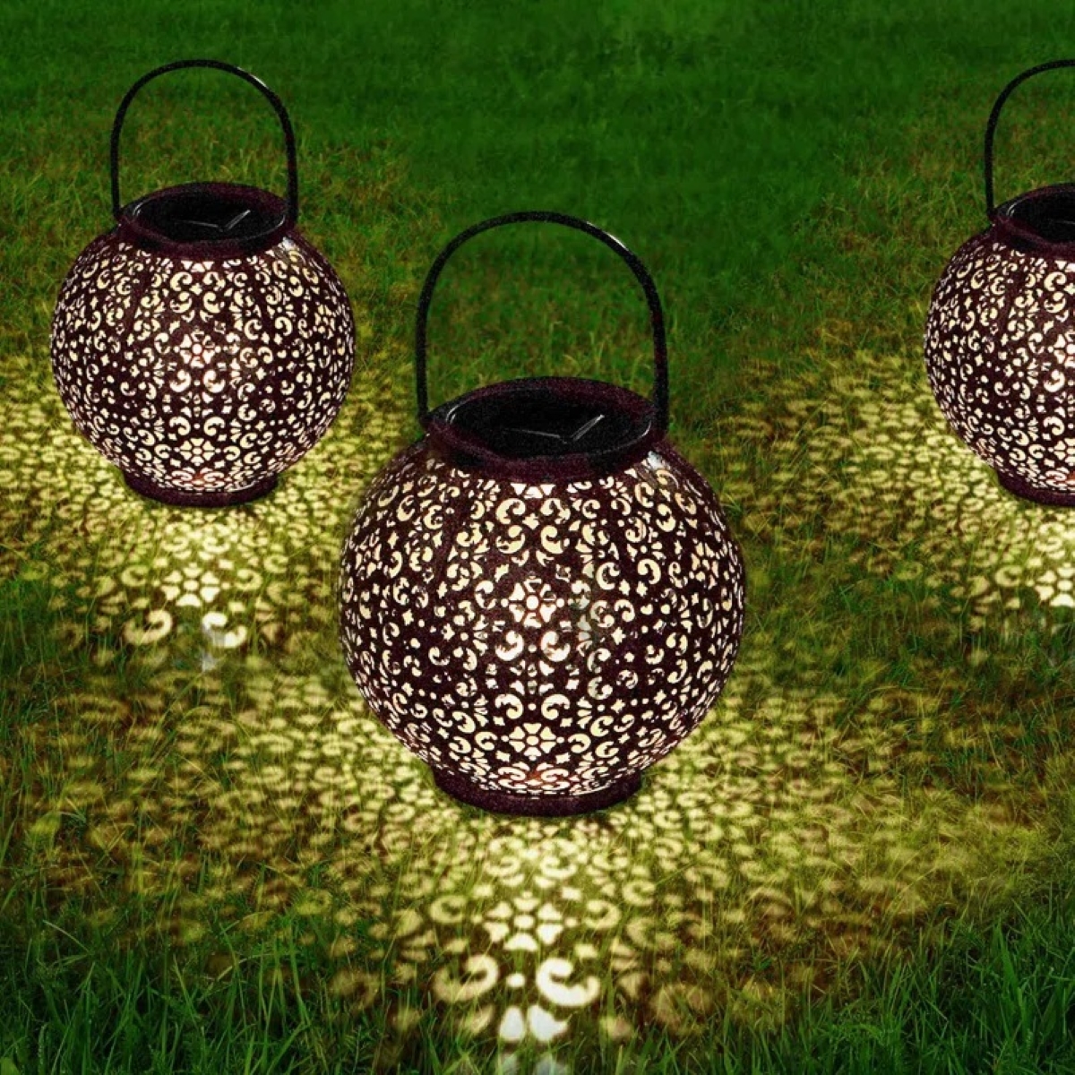 decor with candles - decorative globe candle holders on grass