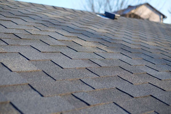 close up of gray-ish asphalt shingles on roof