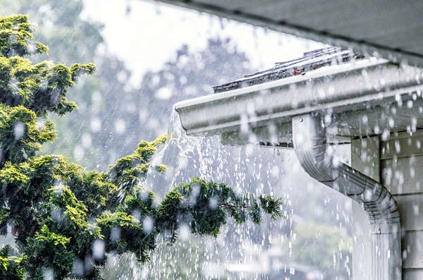 Close up of house gutters seen through the rain