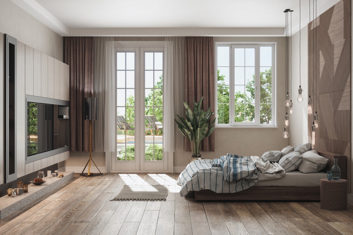 Bedroom with windows looking out on a pool and brown curtains between apron and floor length