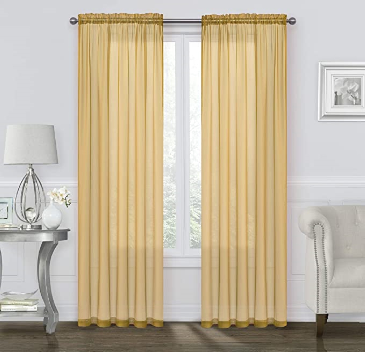 Gold rod pocket panel curtains over window