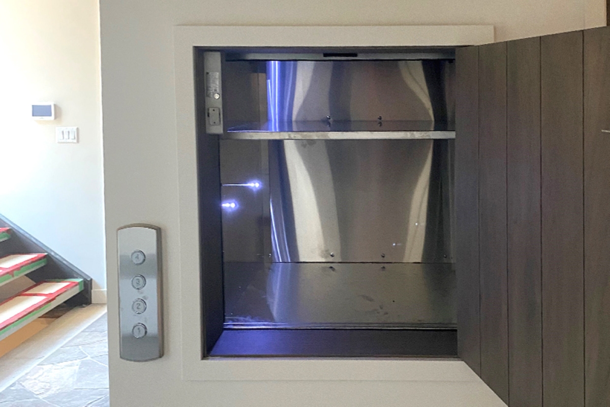 Open empty dumbwaiter installed in wall