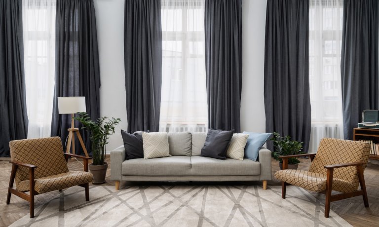 Formal living room curtains in a navy blue color.