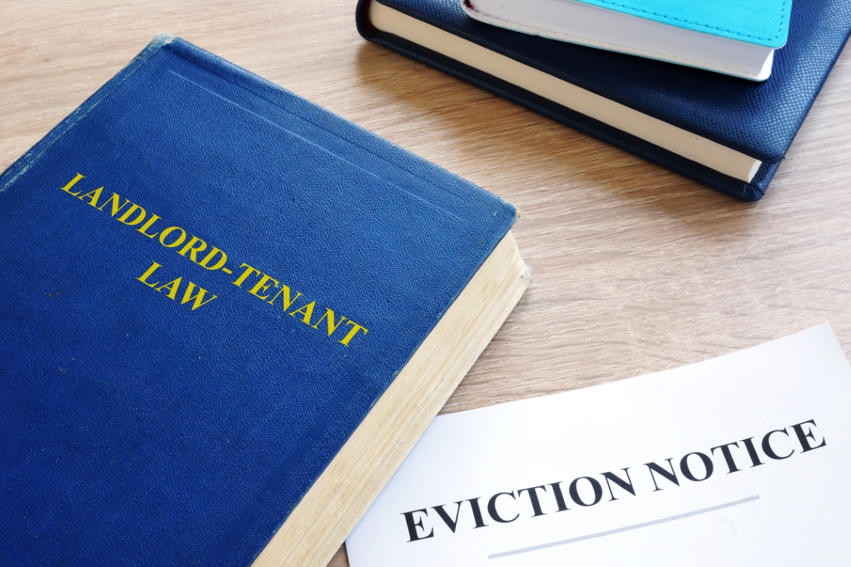 Landlord and Tenant Law book next to eviction documents