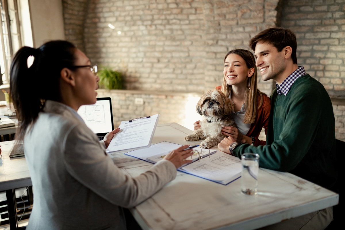 what to know about pet friendly apartments - couple with dog talking to apartment manager