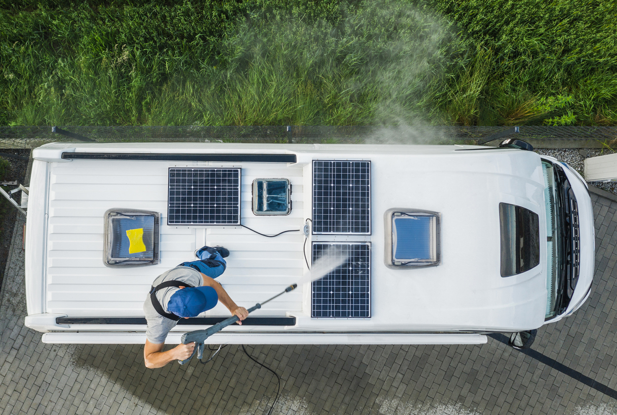 overhead shot of power washing solar panels on roof of RV