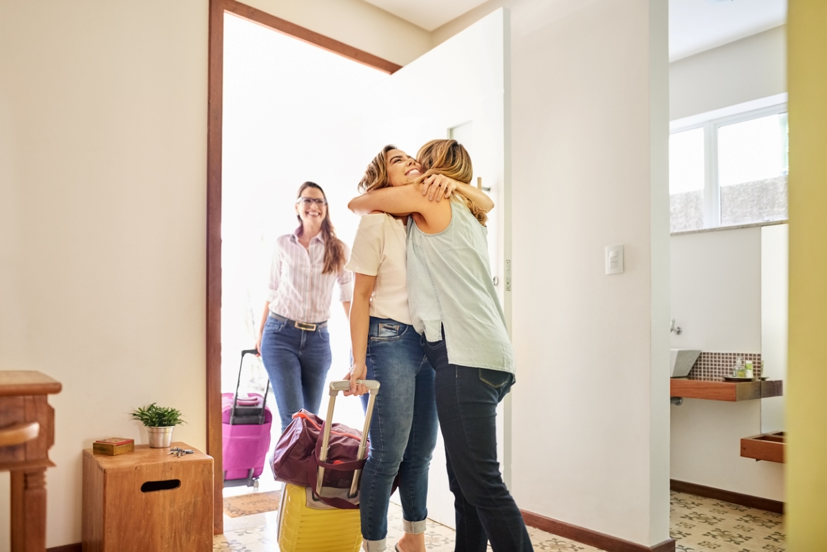 things to look for on your apartment lease - woman welcoming two house guests