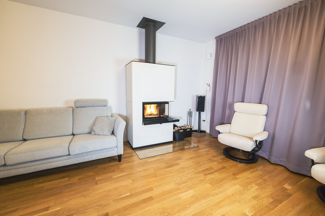 White fireplace, light colored furniture on white wall