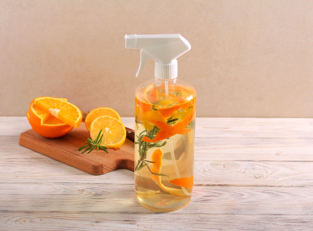 Natural cleaner in spray bottle with orange peels