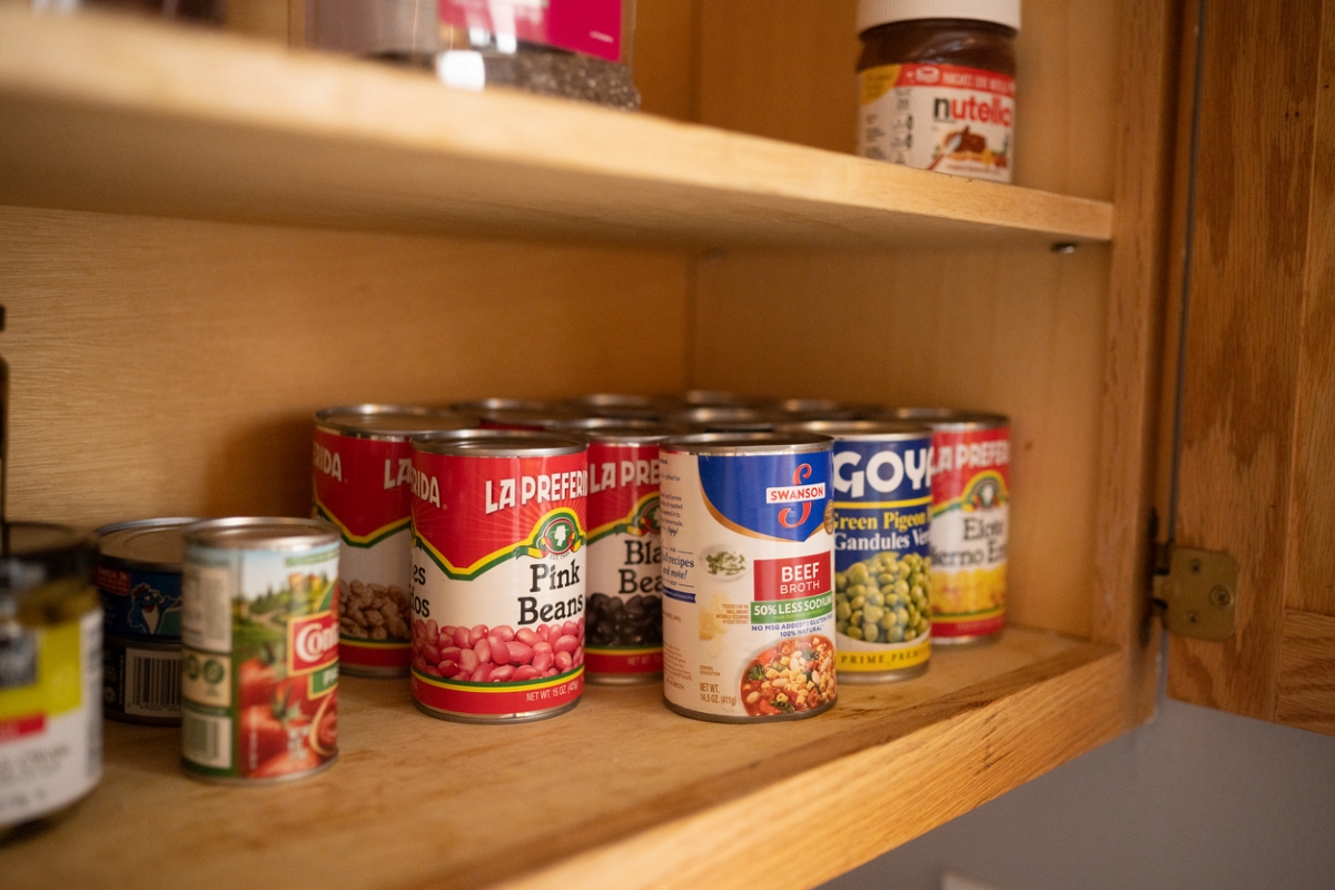 foods that never expire - collection of canned food in wooden cabinet