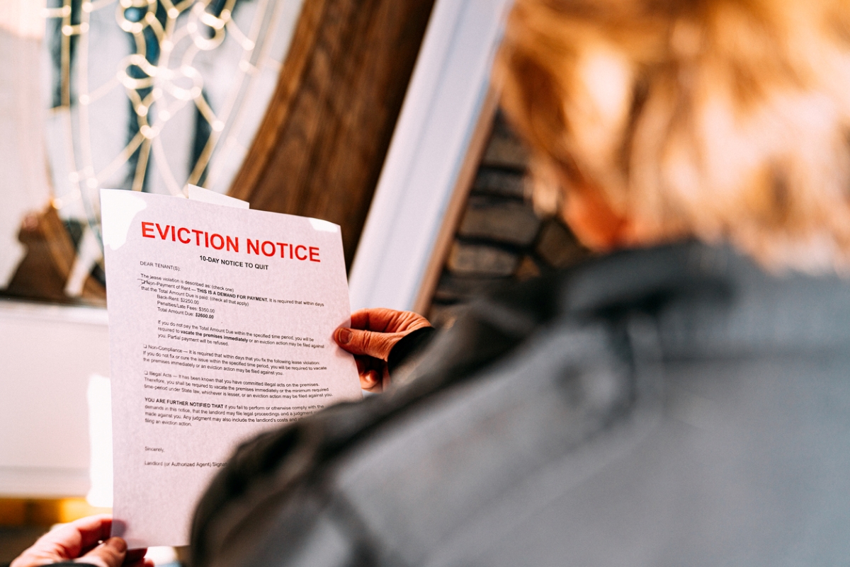 Woman holding eviction poster