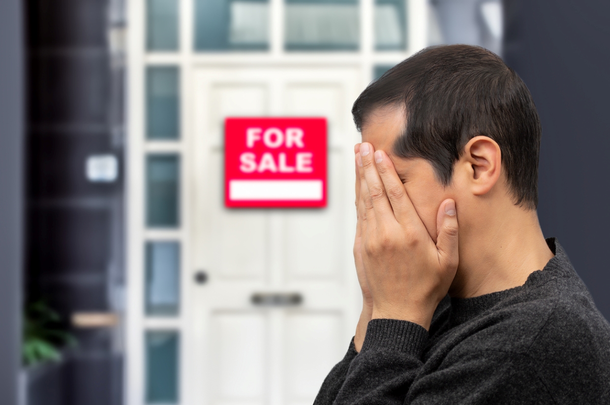 Man upset seeing sale sign on door