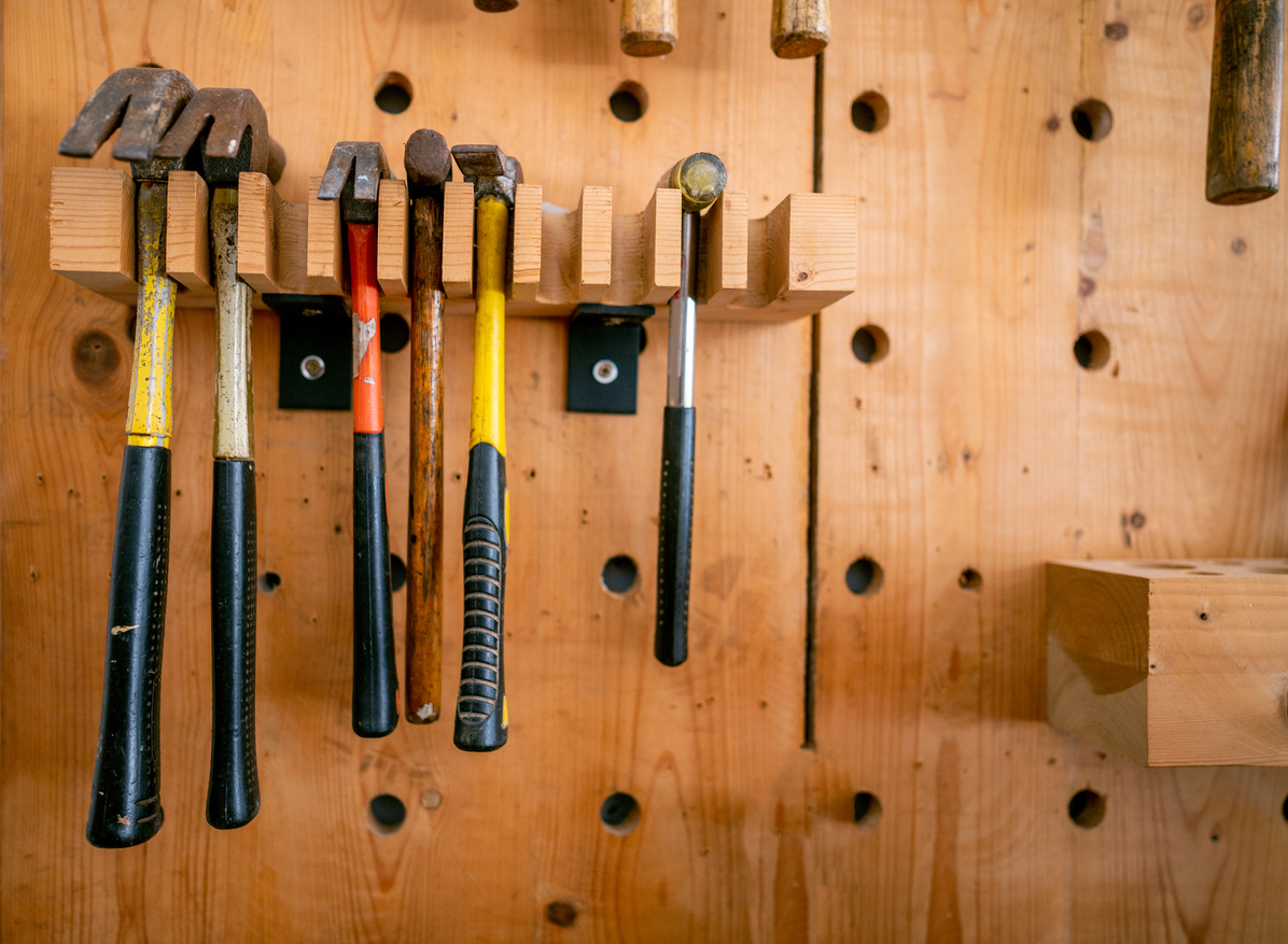 various hammers hanging on workshop wall