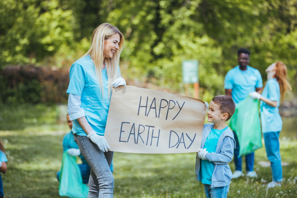 Woman and child holding Happy Earth Day sign