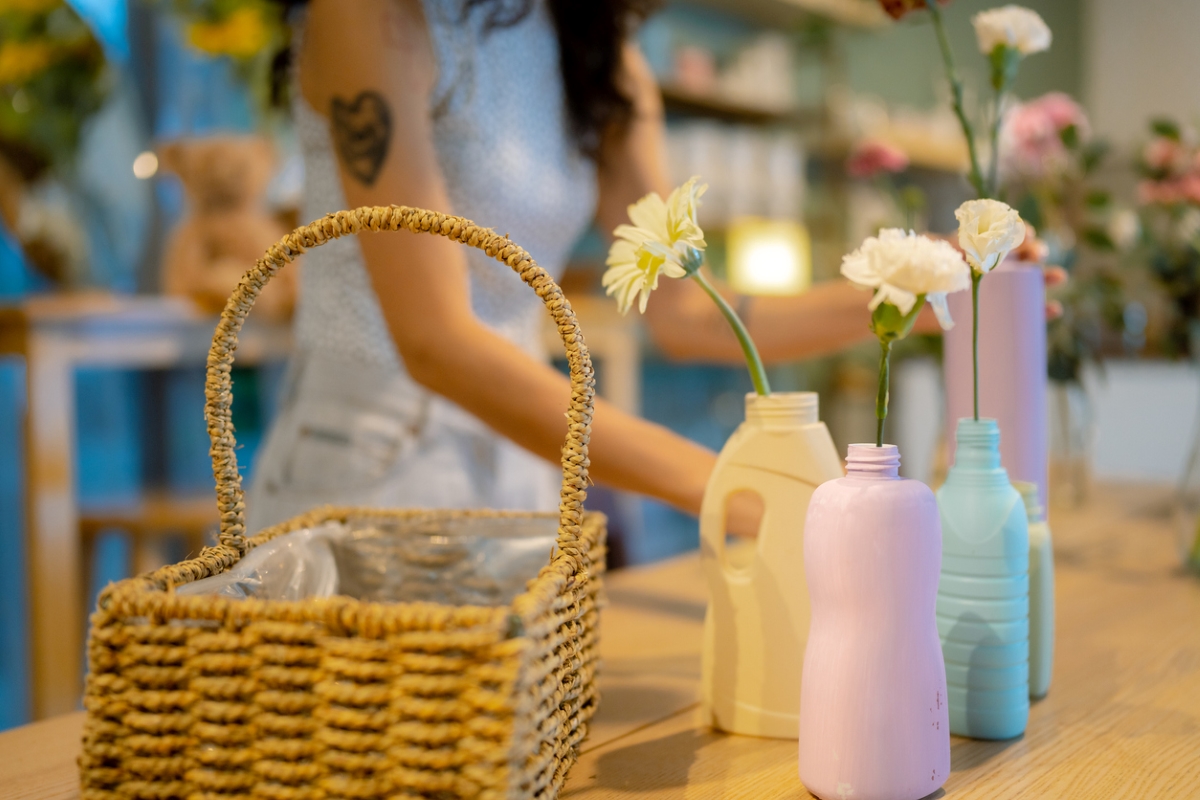 Plastic bottles reused as vases holding single carnations