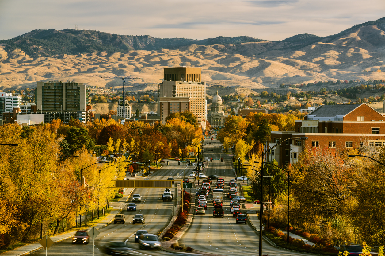 wide view Idaho town traffic homes autumn leaves mountains in distance
