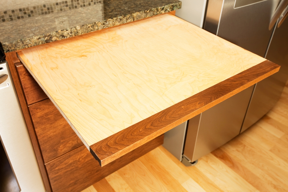 Wooden pull out cutting board from kitchen countertop