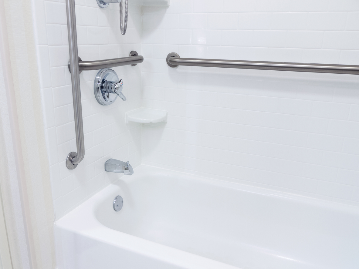 accessible bathroom with grab bars in shower.