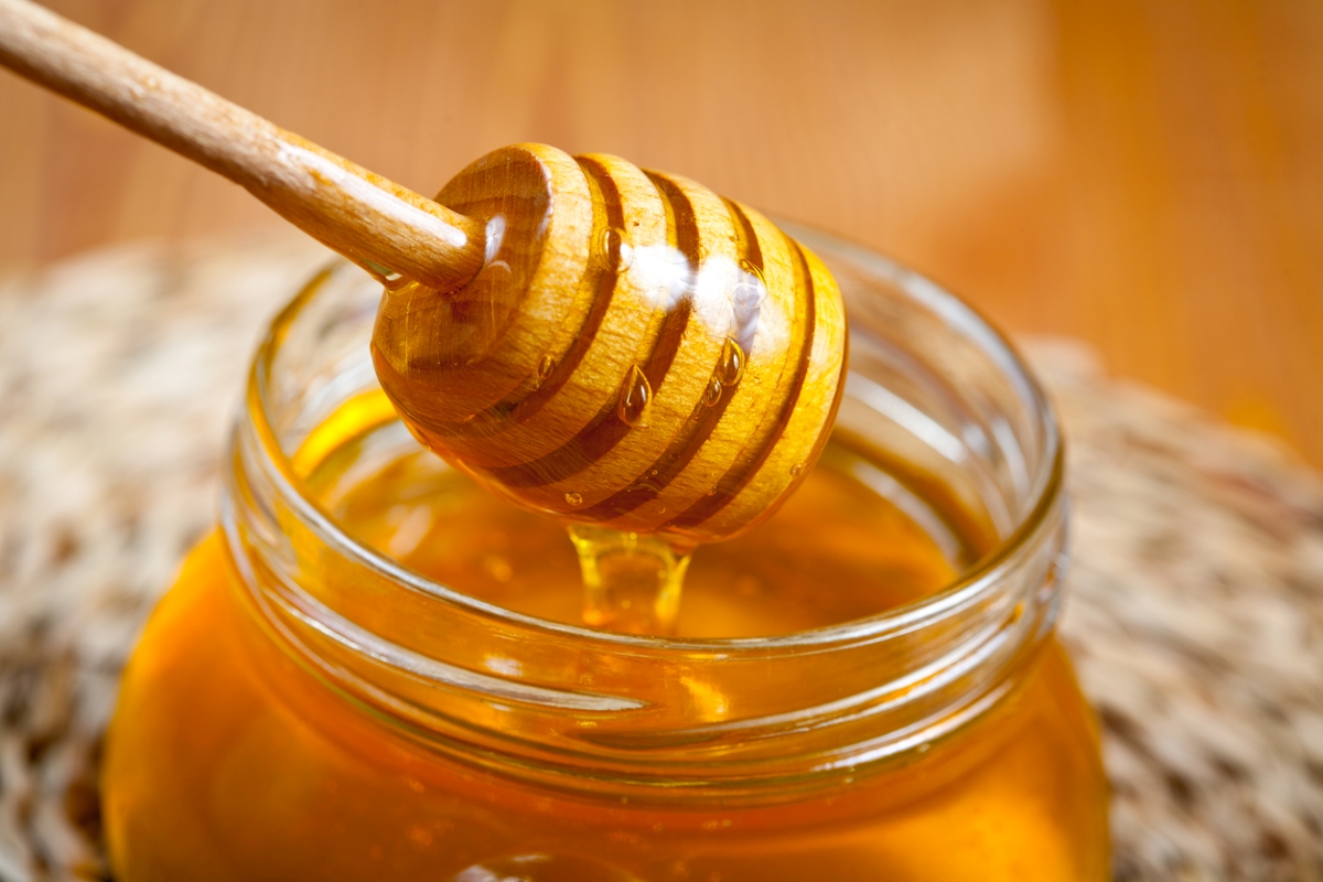 foods that never expire - honey stirrer lifted from honey jar