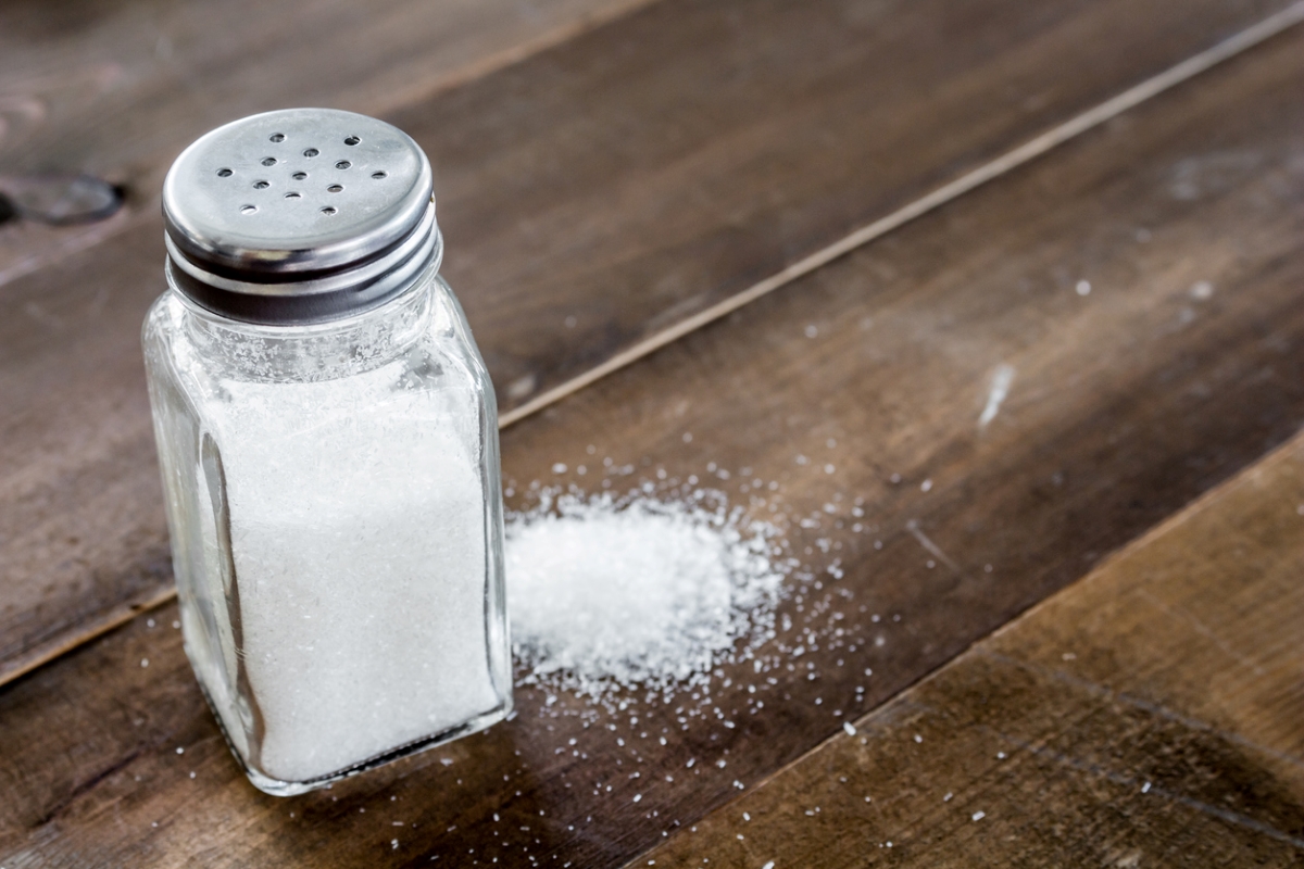 foods that never expire - salt shaker next to loose salt on wooden table