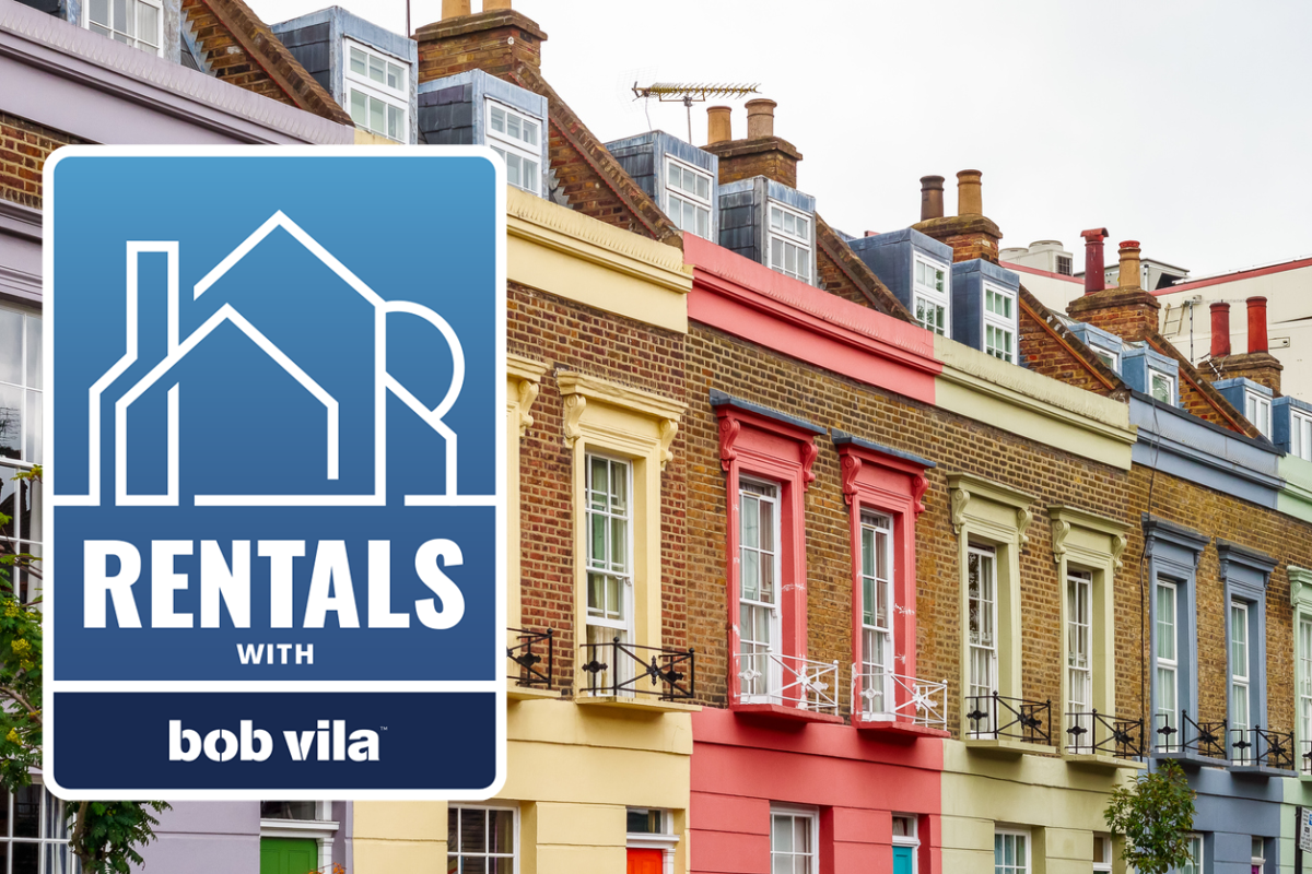 a-row-of-brownstones-with-yellow-red-and-blue-paint-over-brick-behind-a-blue-rectangular-logo-that-reads-Rentals-with-Bob-Vila