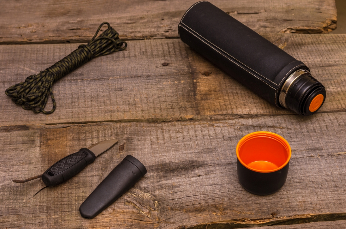 Thermos with knife and paracord
