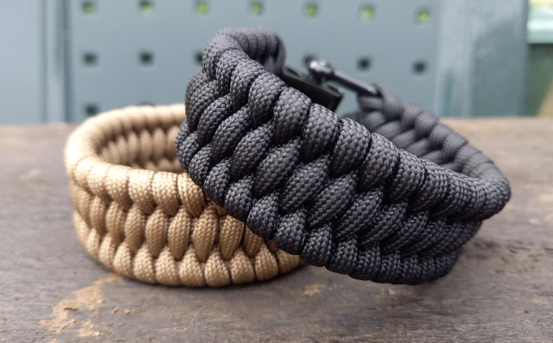 Two paracord bracelets, one beige and one black