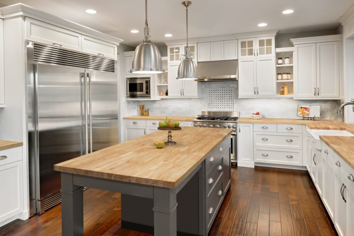 Large modern kitchen with island and butcher block countertops