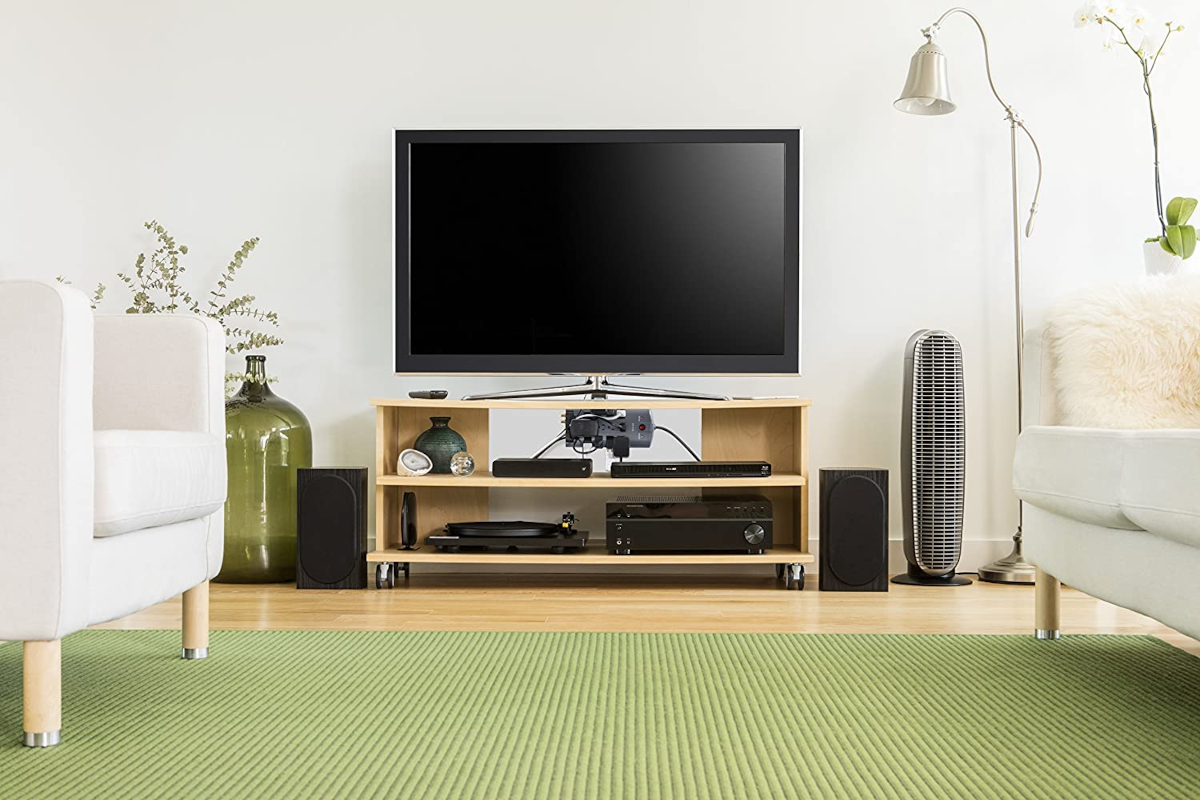 Product photo of a Belkin surge protector connected to multiple living room electronic devices