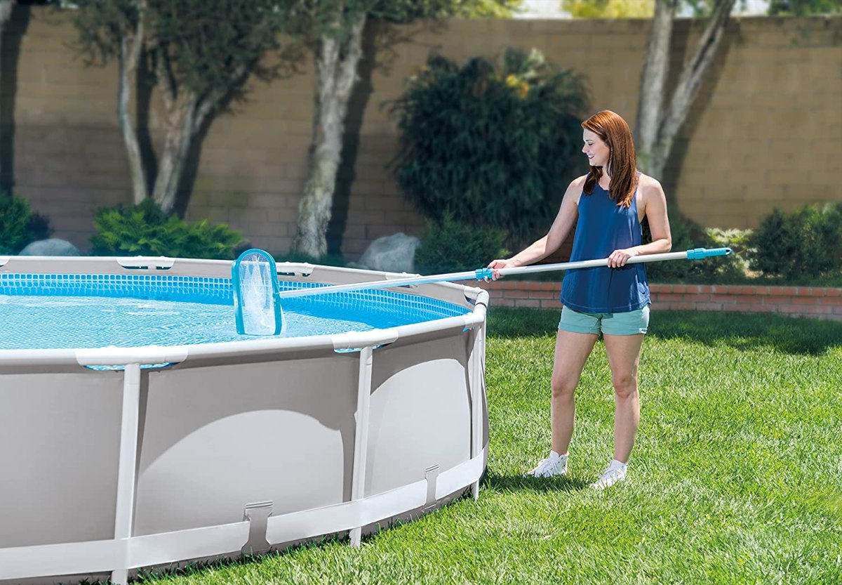 The Best Pool Skimmer option in use by a woman cleaning an above-ground pool