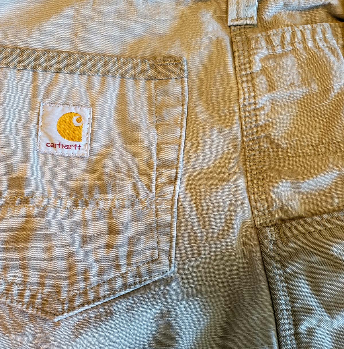 Closeup of Carhartt cargo pants back pocket with logo