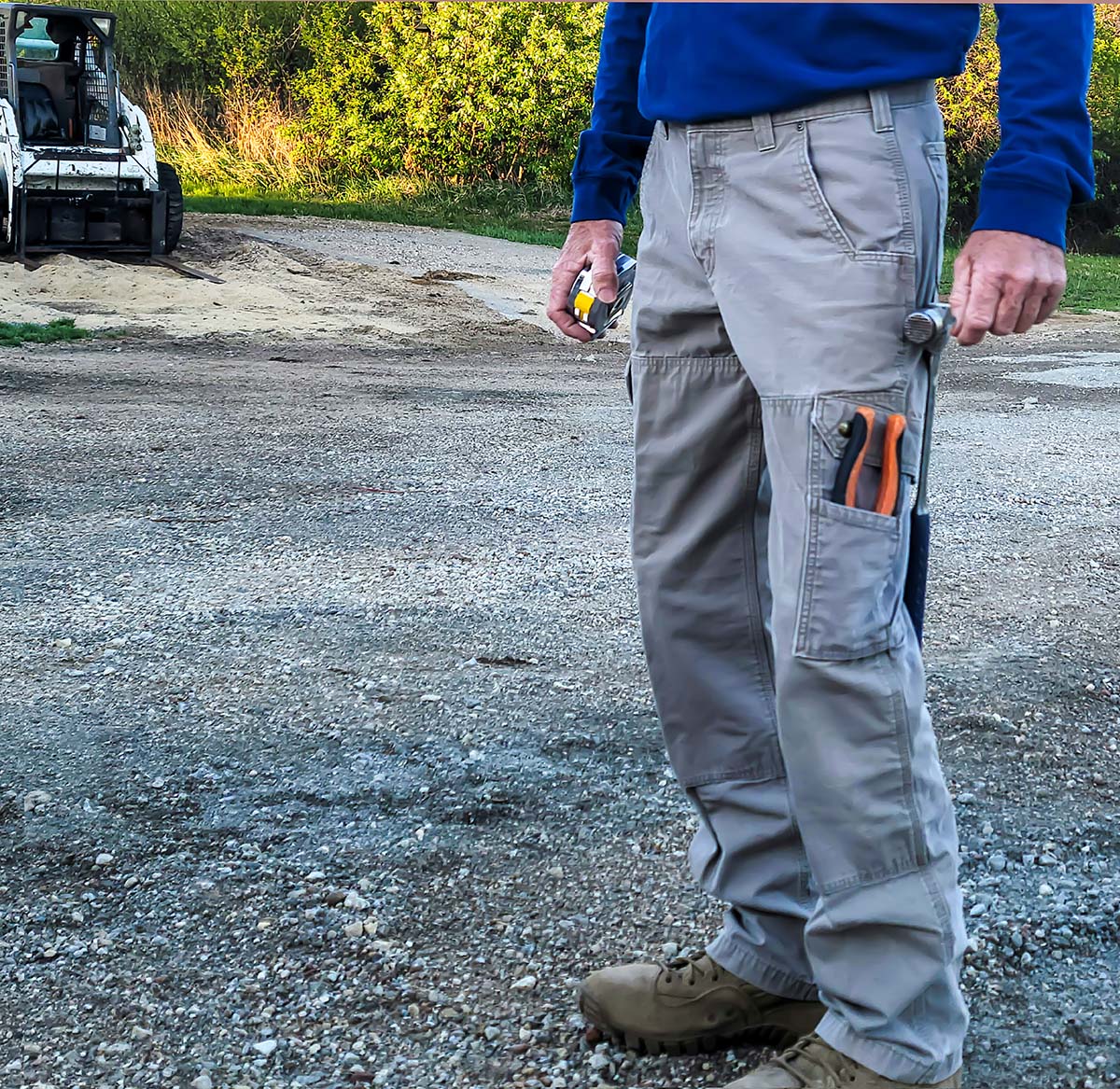 Man wearing Carhartt cargo pants with tools in pockets