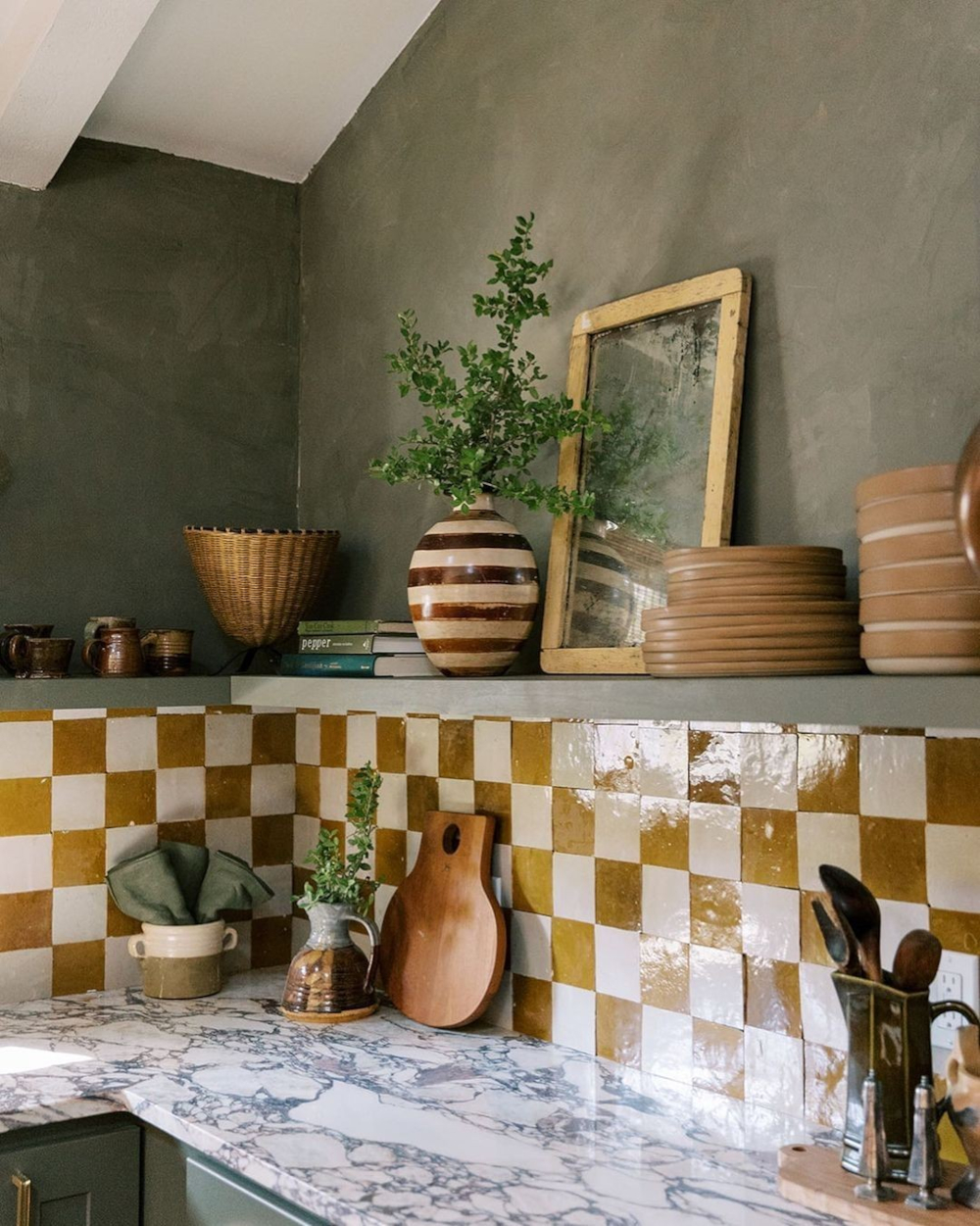 Mediterranean-style kitchen with textured olive paint and glazed checkerboard backsplash