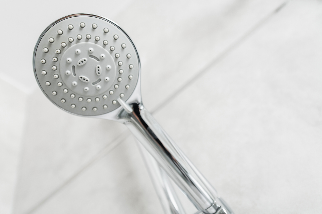 Closeup of a clean chrome shower head with jets