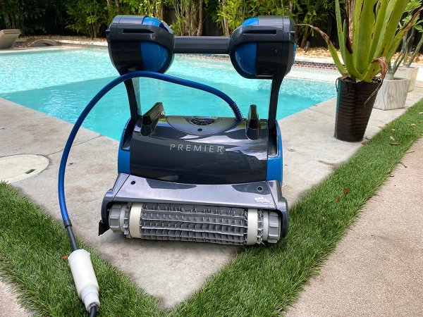 Dolphin Premier Robotic Pool Cleaner sitting outside the corner of a pool