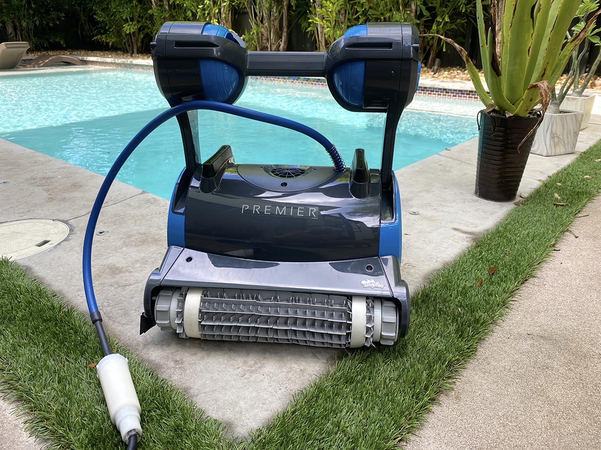 Dolphin Premier Robotic Pool Cleaner sitting outside the corner of a pool
