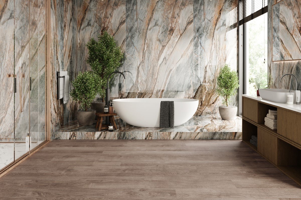 A large modern bathroom with marble walls and brown vinyl tile flooring.