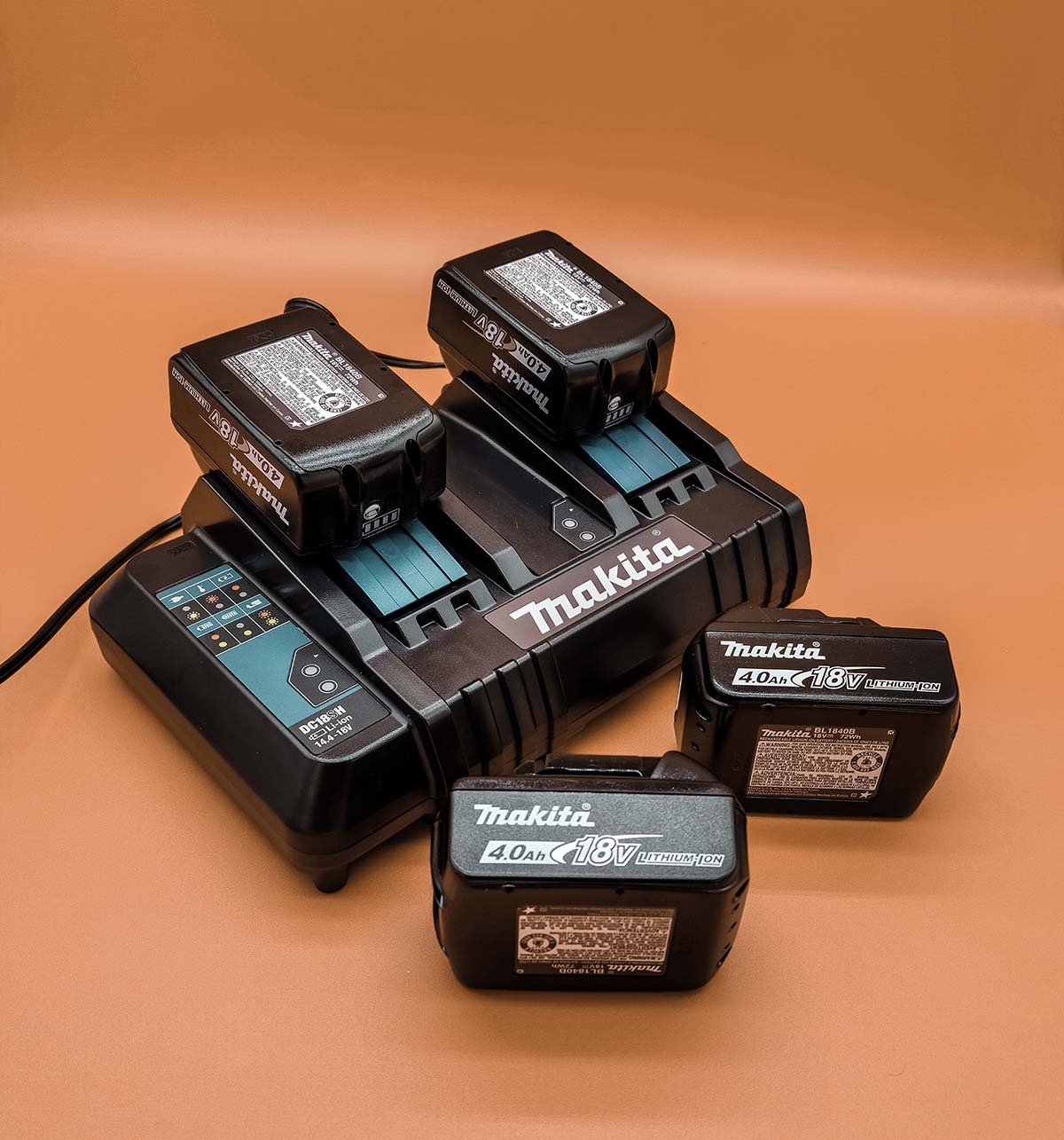 Four lithium-ion batteries and charger for Makita lawn mower
