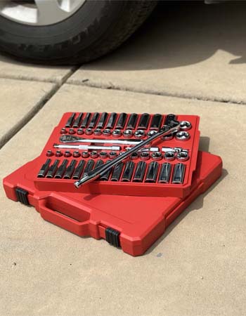 Milwaukee Socket Set and case near car on driveway