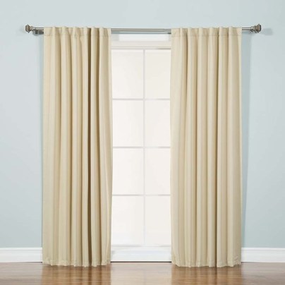 The Best Home Fashion Wide Basic Thermal Blackout Curtain installed over a patio door.