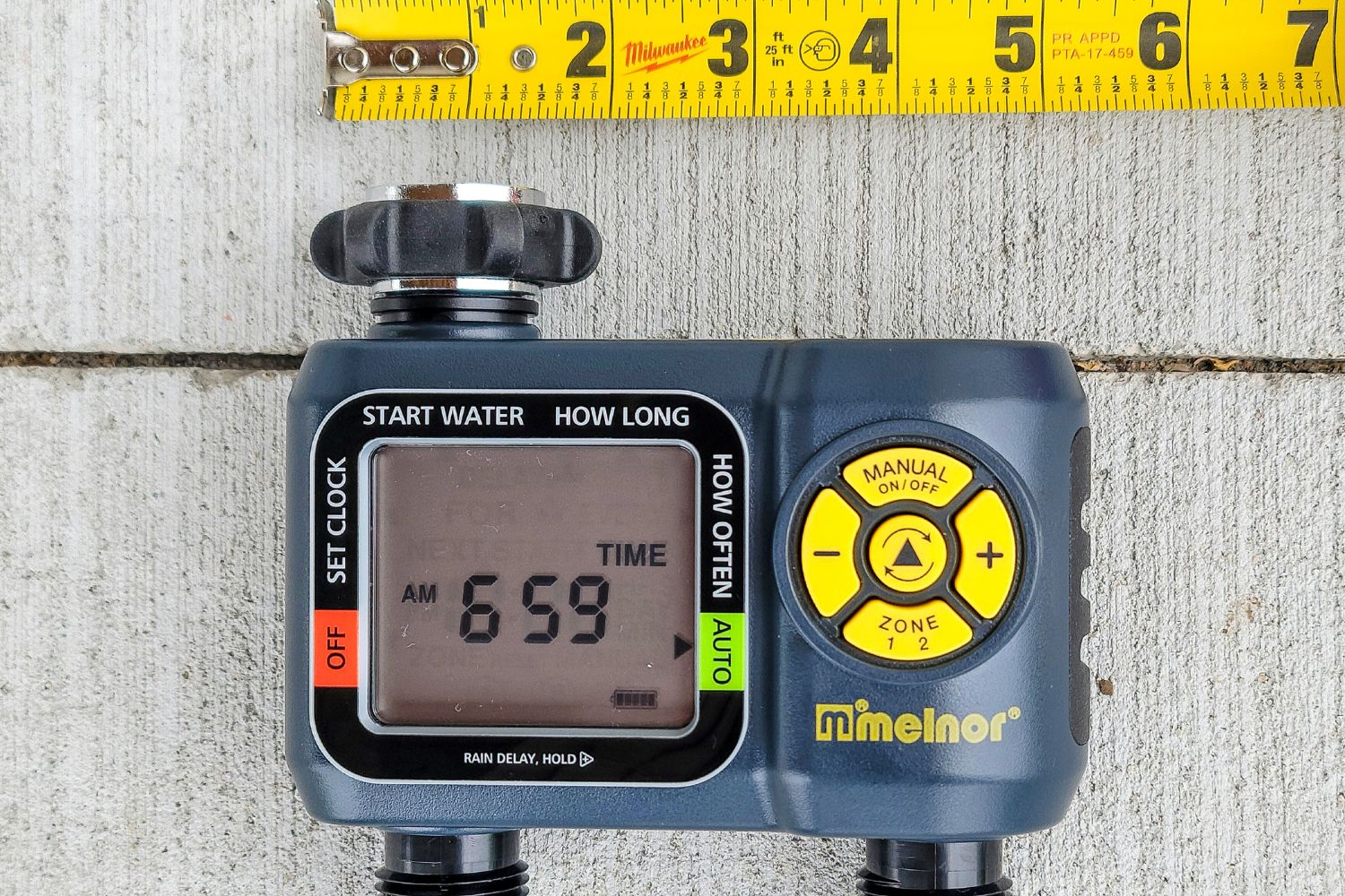 Melnor dual zone hose timer on cement walkway measuring 5 inches