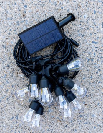 Brightech solar string lights wrapped up and laying on patio