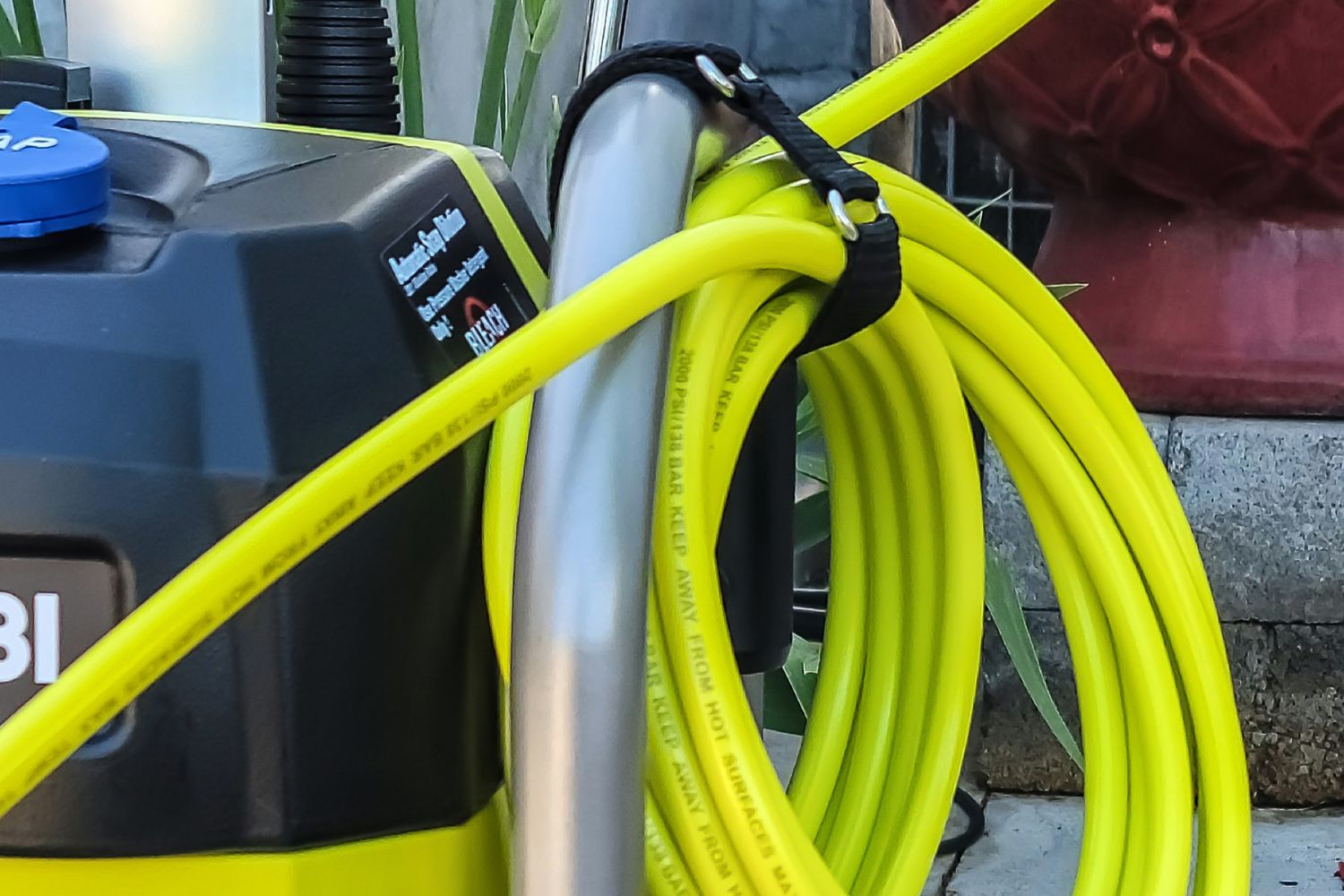 A close-up of the Ryobi pressure washer 2000 PSI's onboard cord storage