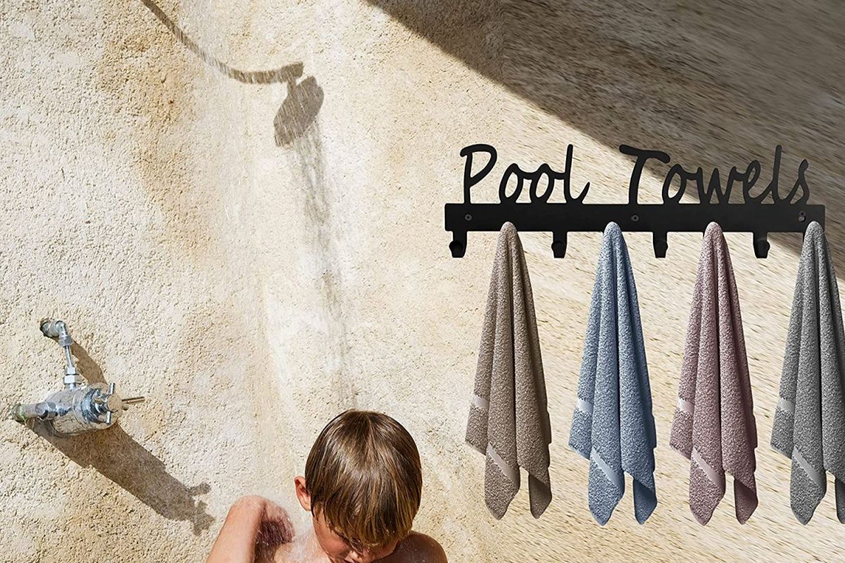 The Best Outdoor Towel Racks Option hangs on the wall next to an outdoor shower