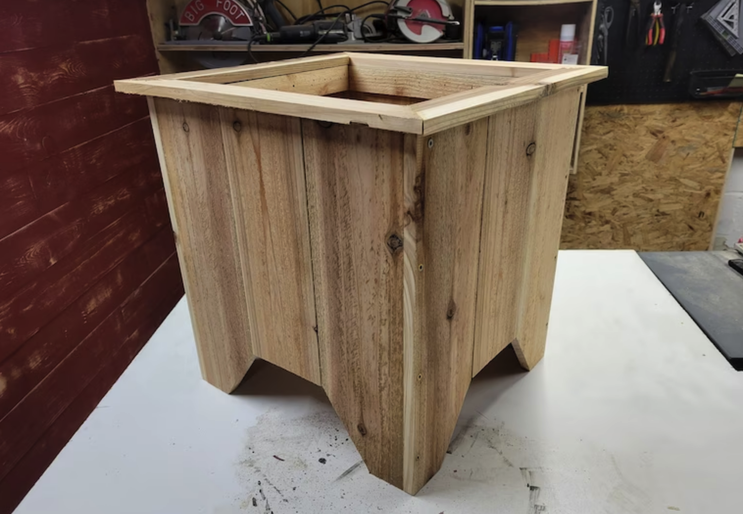 large wooden planter box on top of table in workshop