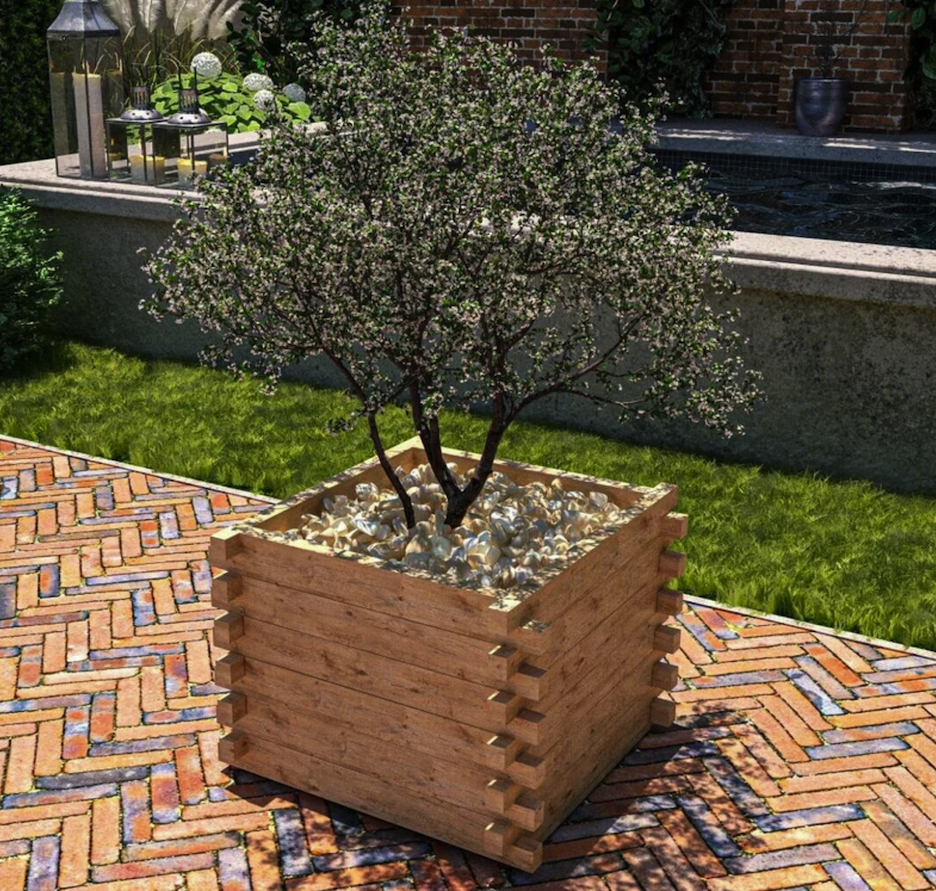 small flowering tree in a square planter on stone patio